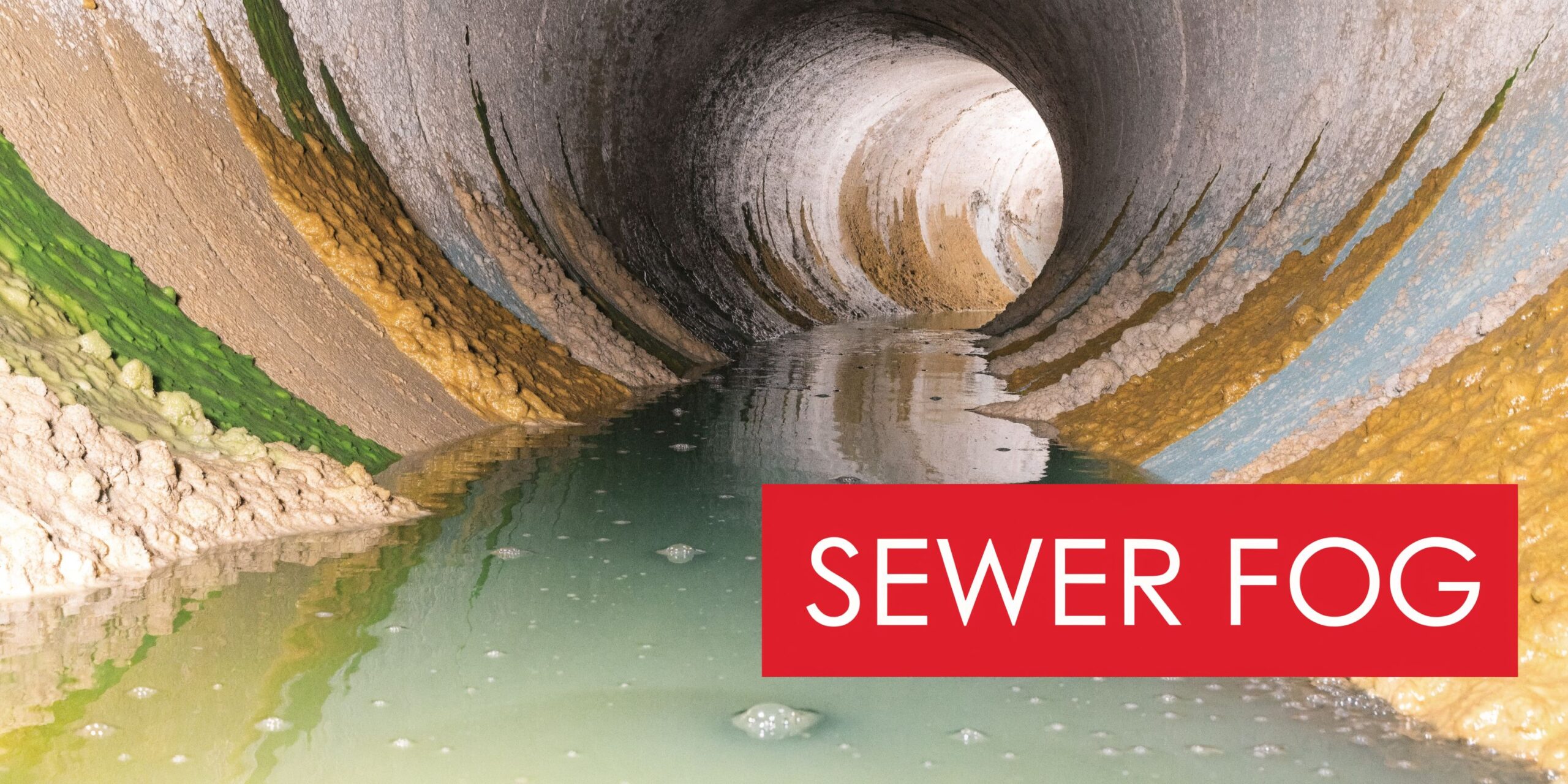 A View Inside A Sewer Pipe Containing A Layer Of Solidified Grease Deposits And Wastewater Buildup.
